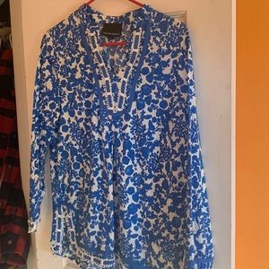 Women’s top blue and white print with detailing at neck, cuffs and hem.